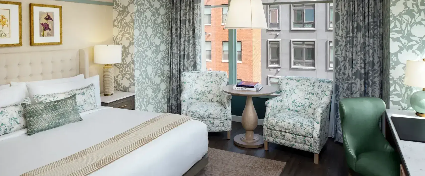 Modern studio guestroom at The Benson Hotel with king bed and sitting area